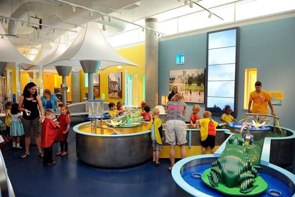 An image of inside the Discovery zone exhibit, where children have a chance to learn and play with a water feature.
